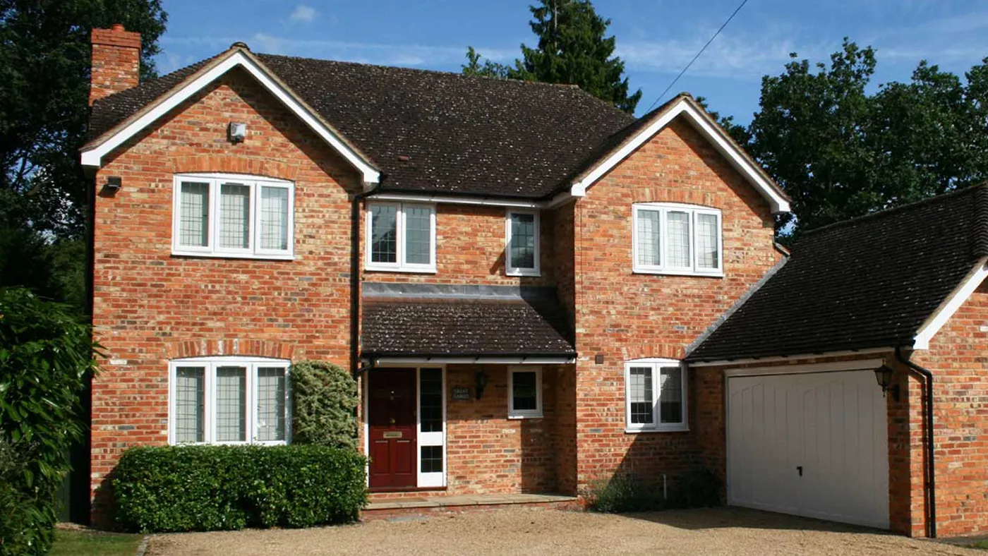 White uPVC casement windows fitted to detached red brick house, Gerrards Cross
