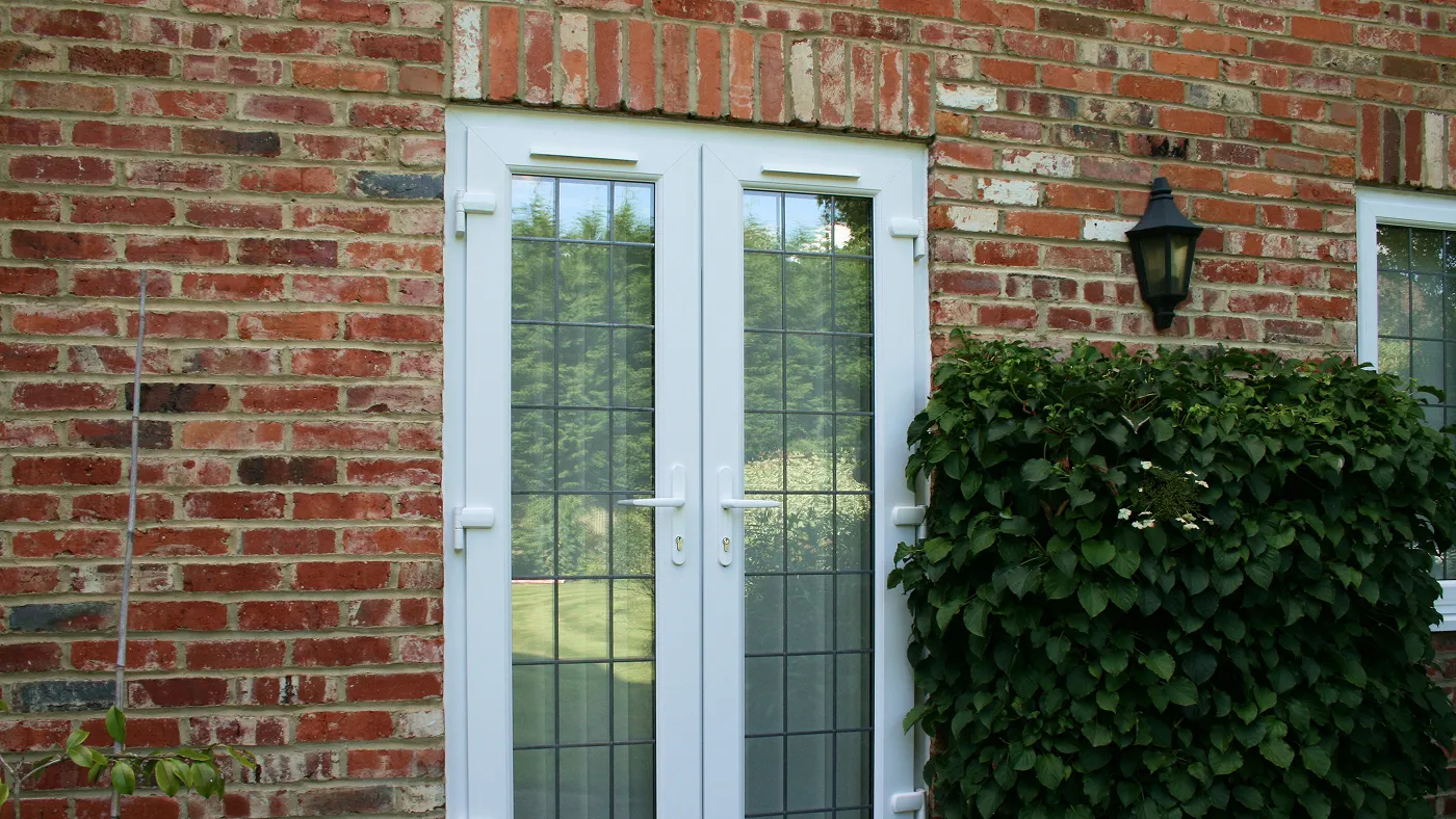 White French doors and side lights on red brick house, Gerrards Cross