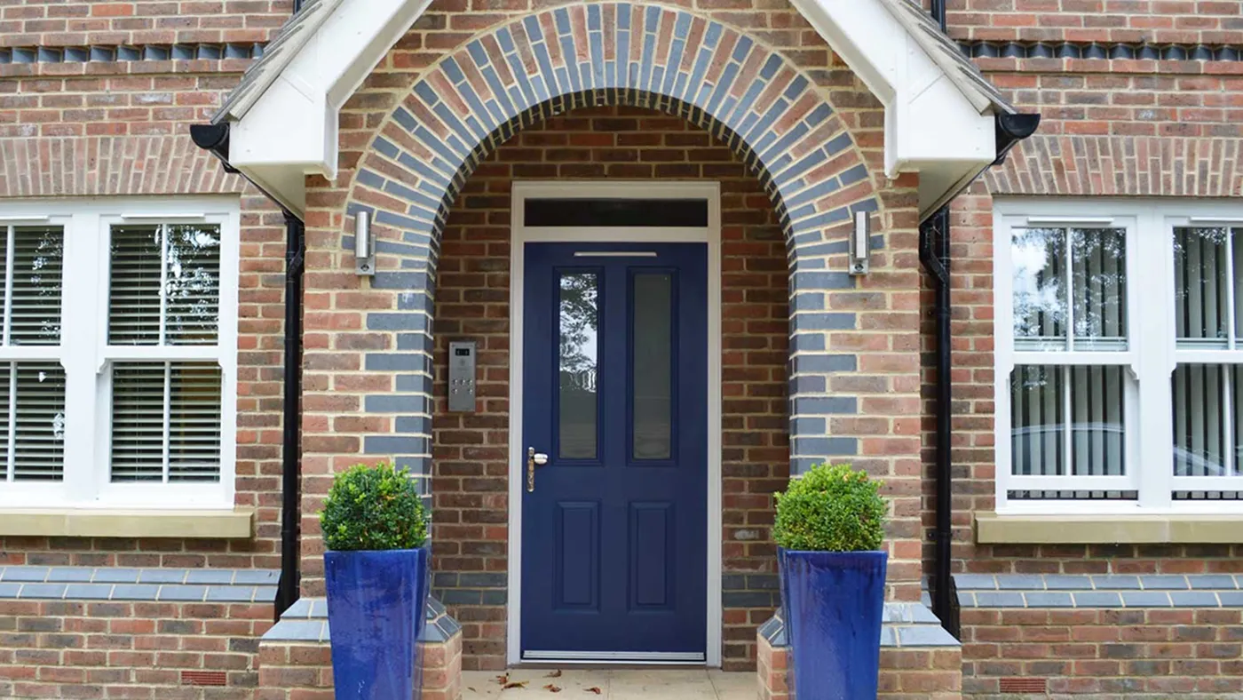 Navy blue composite door in brick arched porch, Gerrards Cross