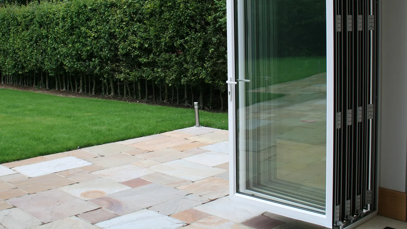 White aluminium bi-fold doors opening onto garden, Marlow