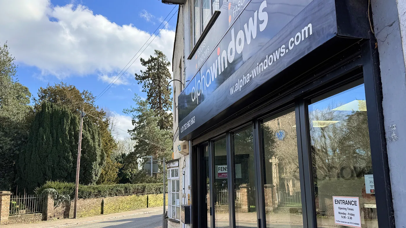 Exterior of Alpha Windows showroom in Iver with the parish church visible opposite