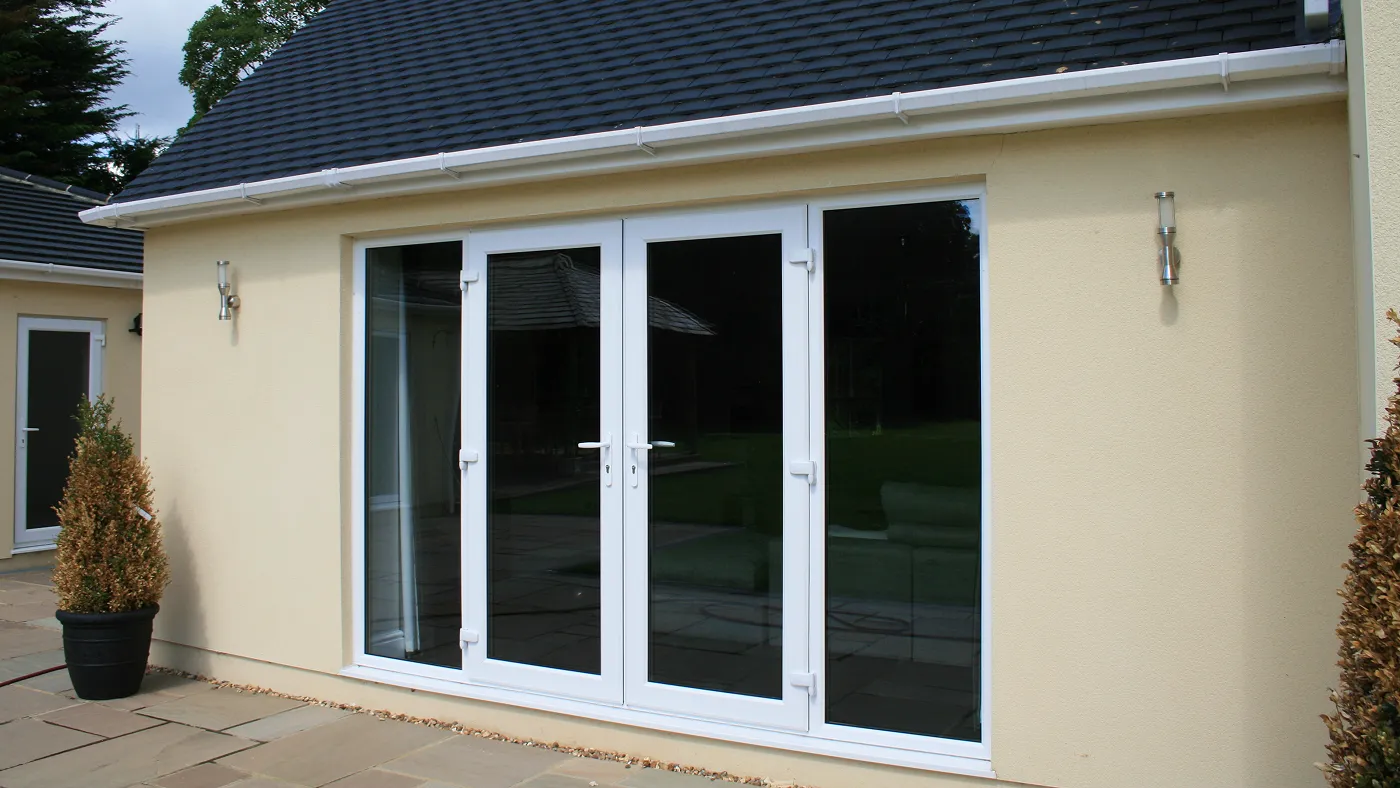 White French doors and side windows on rendered bungalow, Denham