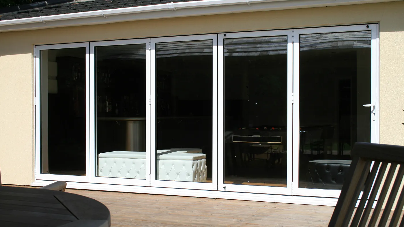 White bi-fold doors across rear of bungalow extension, Beaconsfield