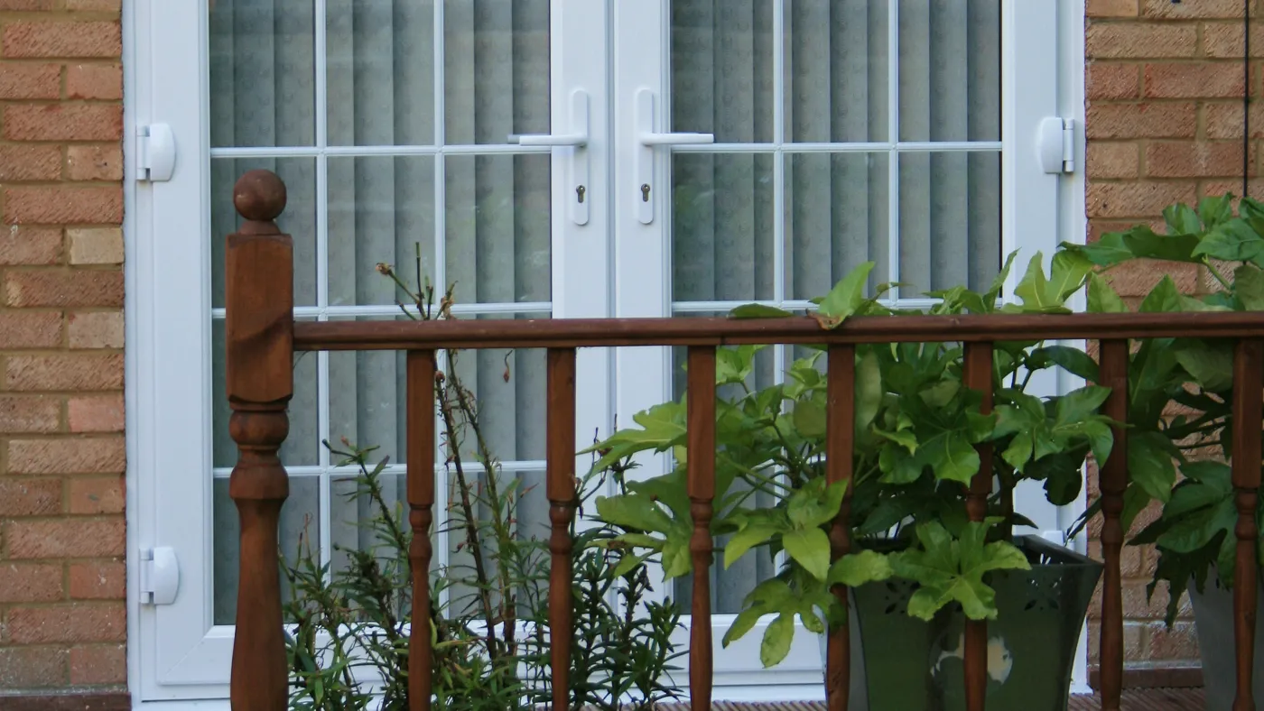 White uPVC French doors with glazed panels fitted on a traditional property in Iver