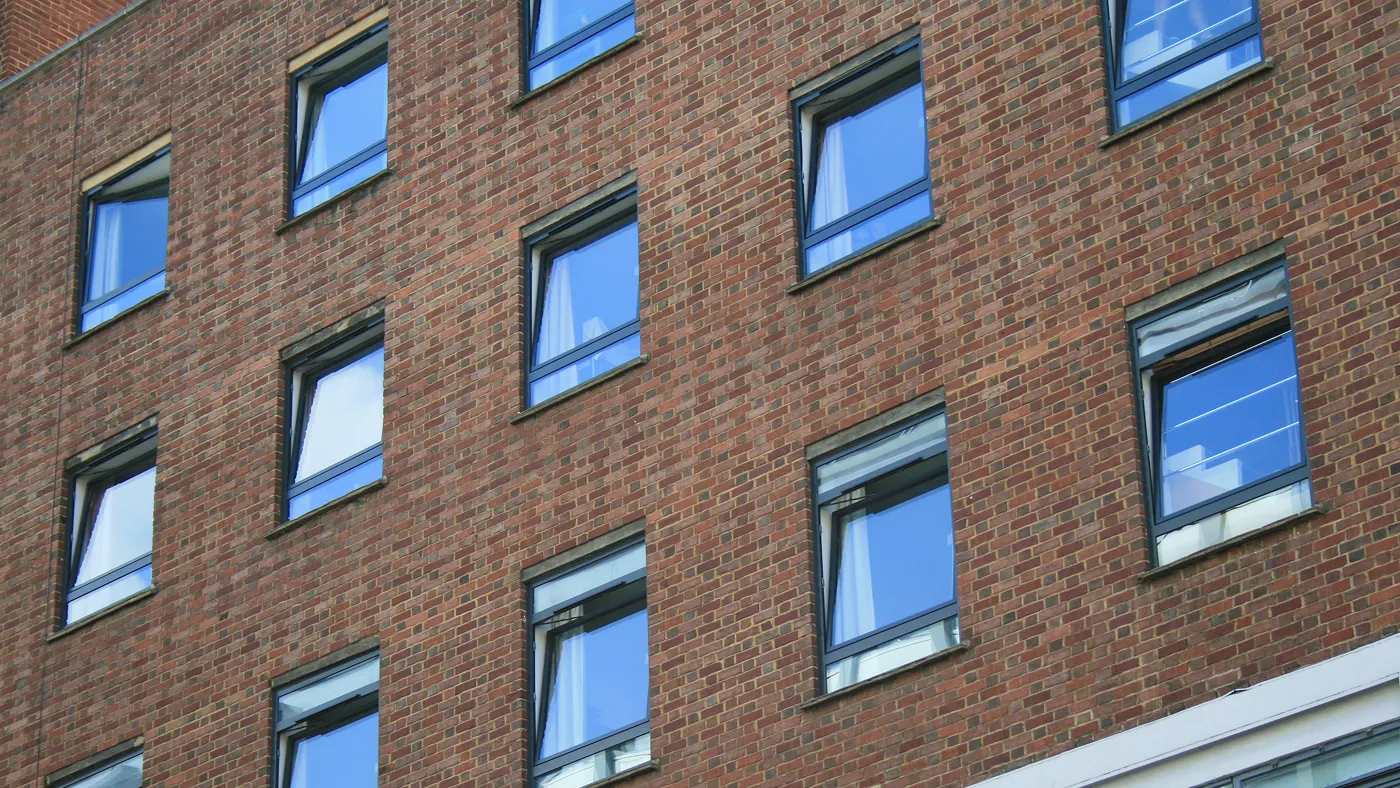 Anthracite tilt and turn windows across multi-storey building, London