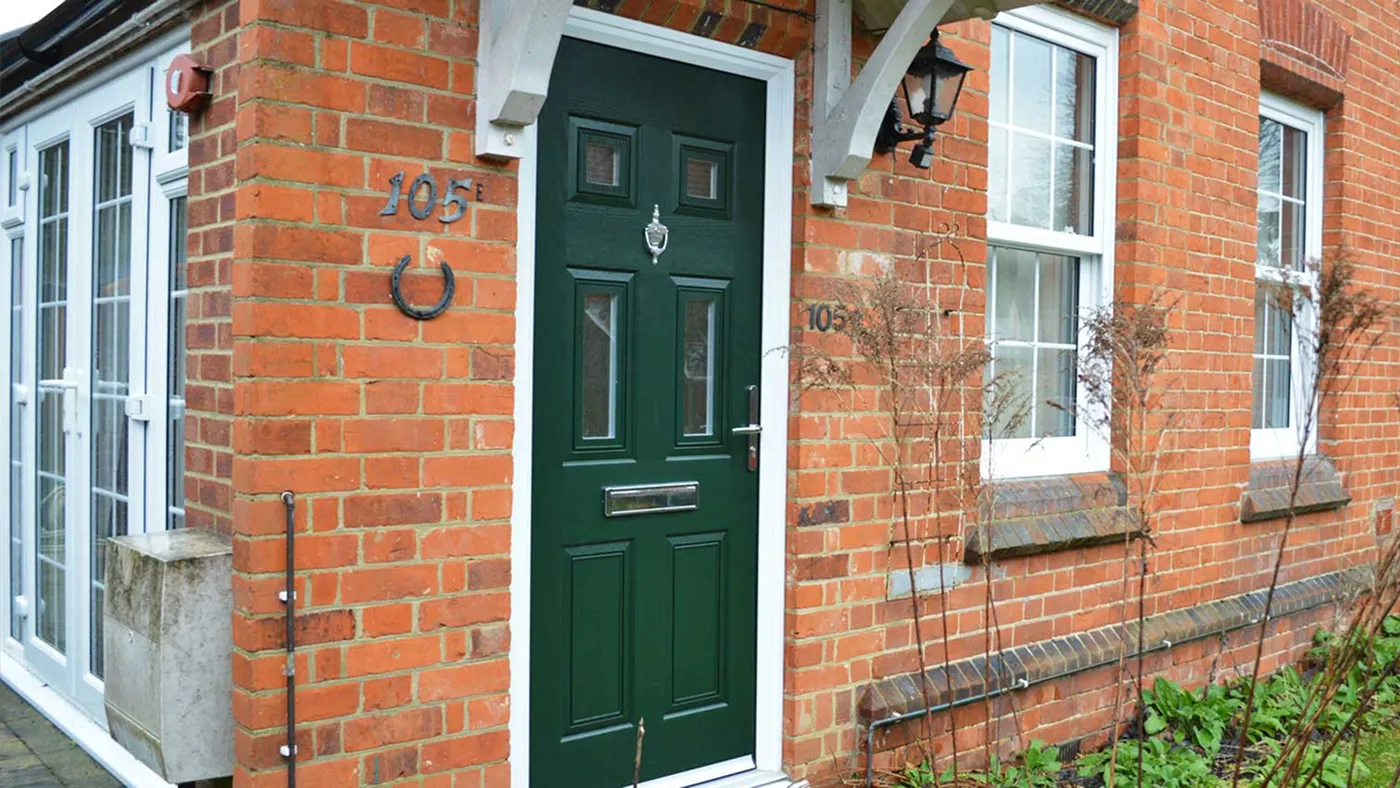 Dark green composite door on traditional red brick home, Amersham