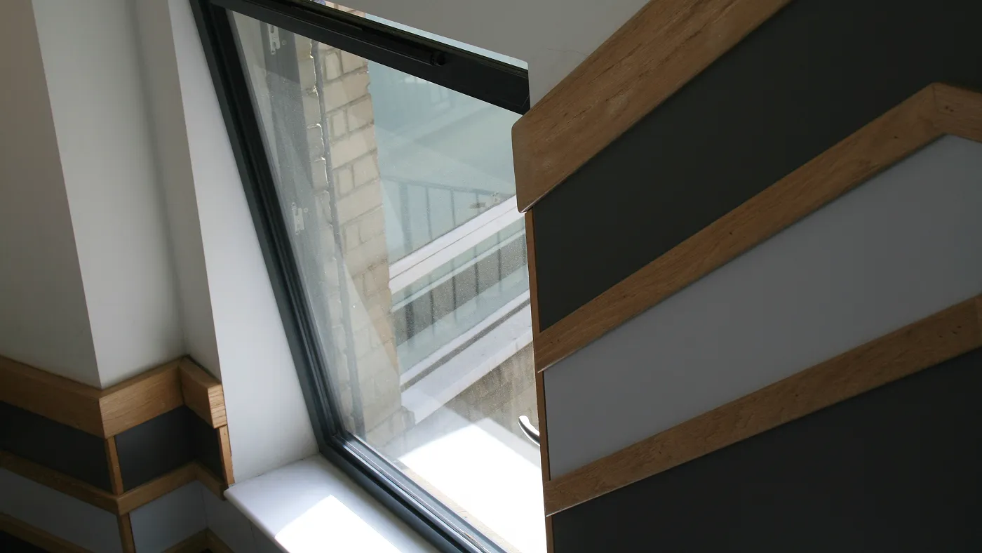 Interior close-up of tilt and turn window hardware and frame detail