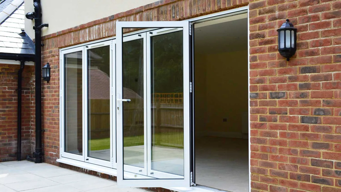 White sliding bi-fold doors on modern property with garden, Windsor