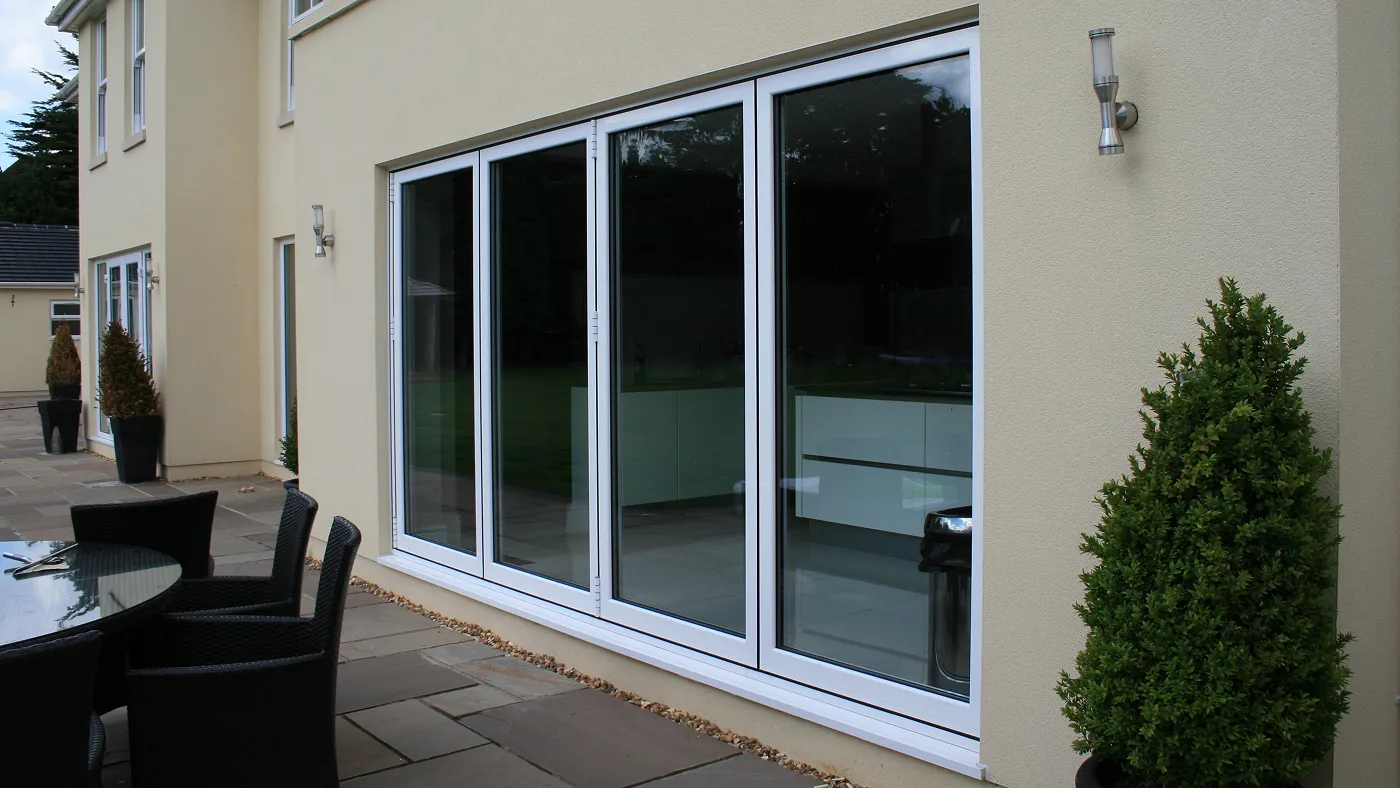 White aluminium bi-fold doors opening onto garden, Iver