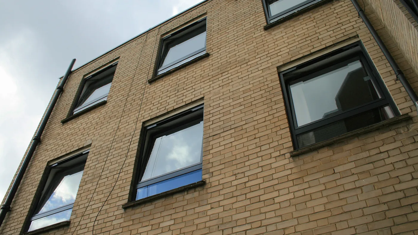 Tilt and turn windows on corner elevation of brick building, Marlow