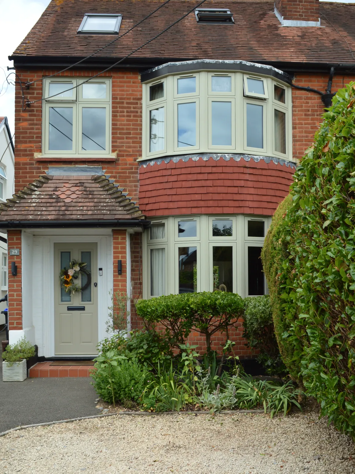 Cream-framed bay window on a brick house